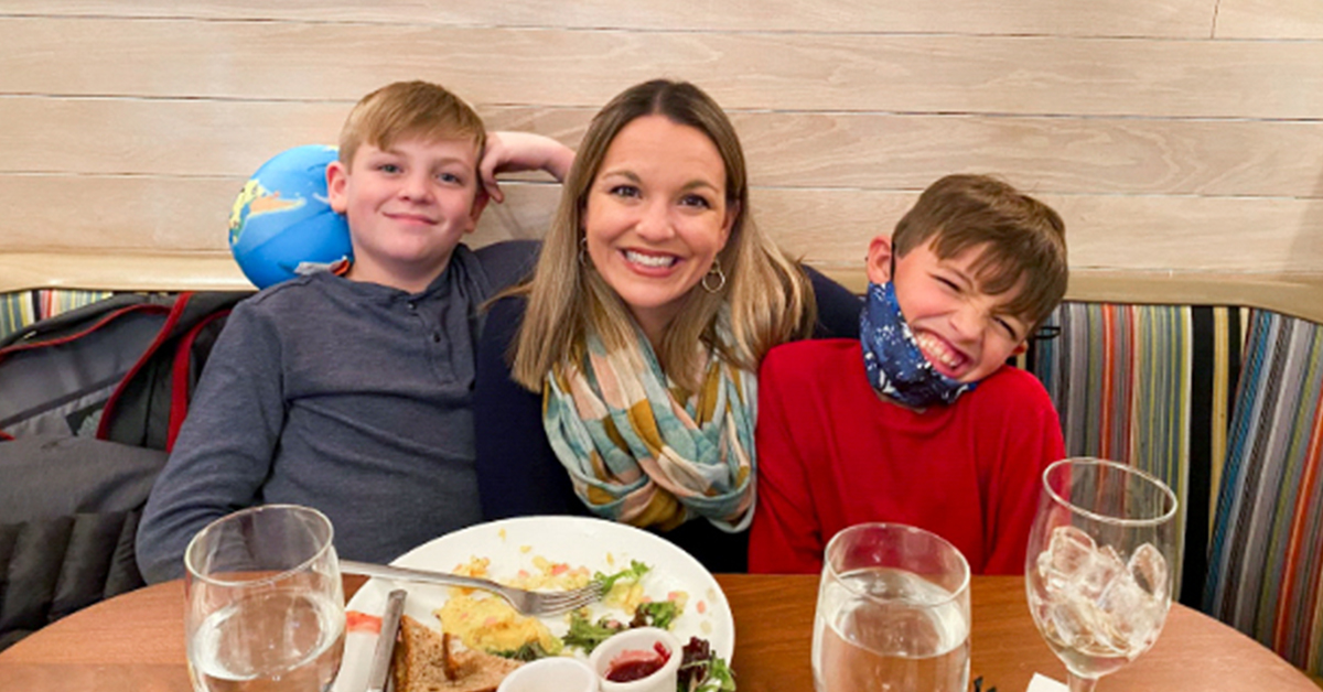 Christina McClung, Capital One associate, sits in a restaurant booth with her two sons.