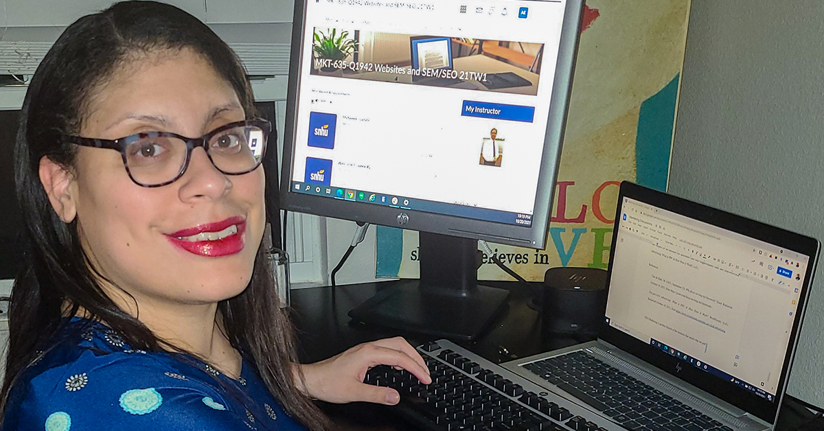 Ashley, Capital One associate, sits at her computers at her home office talking about tuition reimbursement