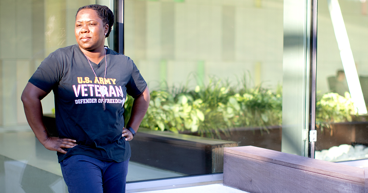 Capital One veteran stands outside and talks about transitioning military skills into a career. 