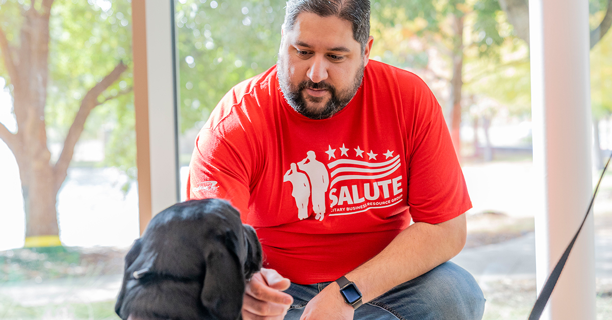 Capital One associate kneels to pet Veterans