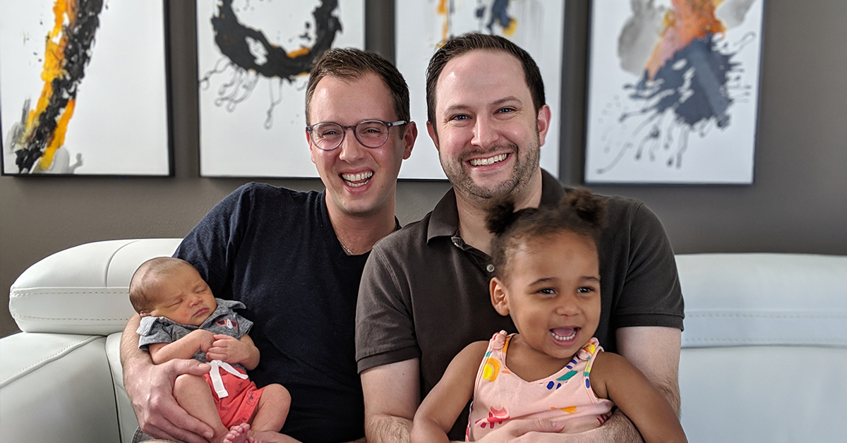 Ethan, a Capital One associate, sits with his husband and two children and talks about the adoption benefits at Capital One