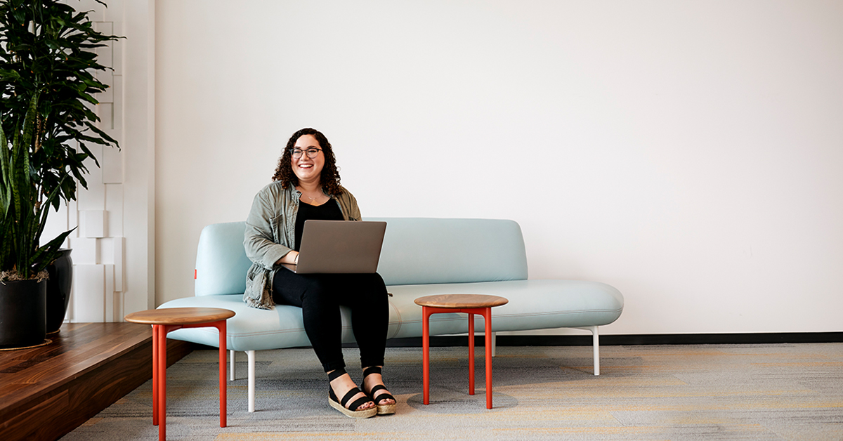Capital One student and grad associate sits on a couch in a Capital One building and talks about her internship program