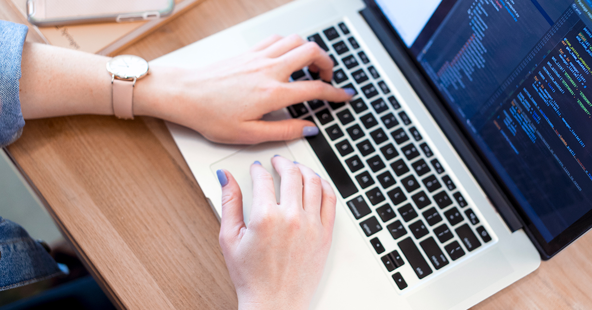 Capital One associate works on laptop