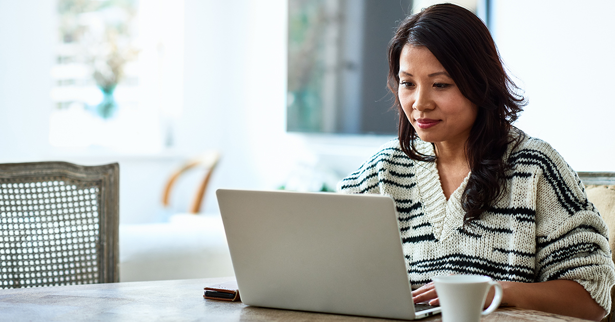 Woman sits at laptop and talks about the Julie A. Elberfeld Tech Diversity and Inclusion awards at Capital One