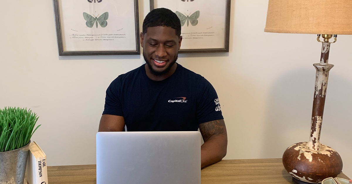 Jarrod, a software engineer at Capital One, smiles while he works from home and talks about his Tech team's open communication