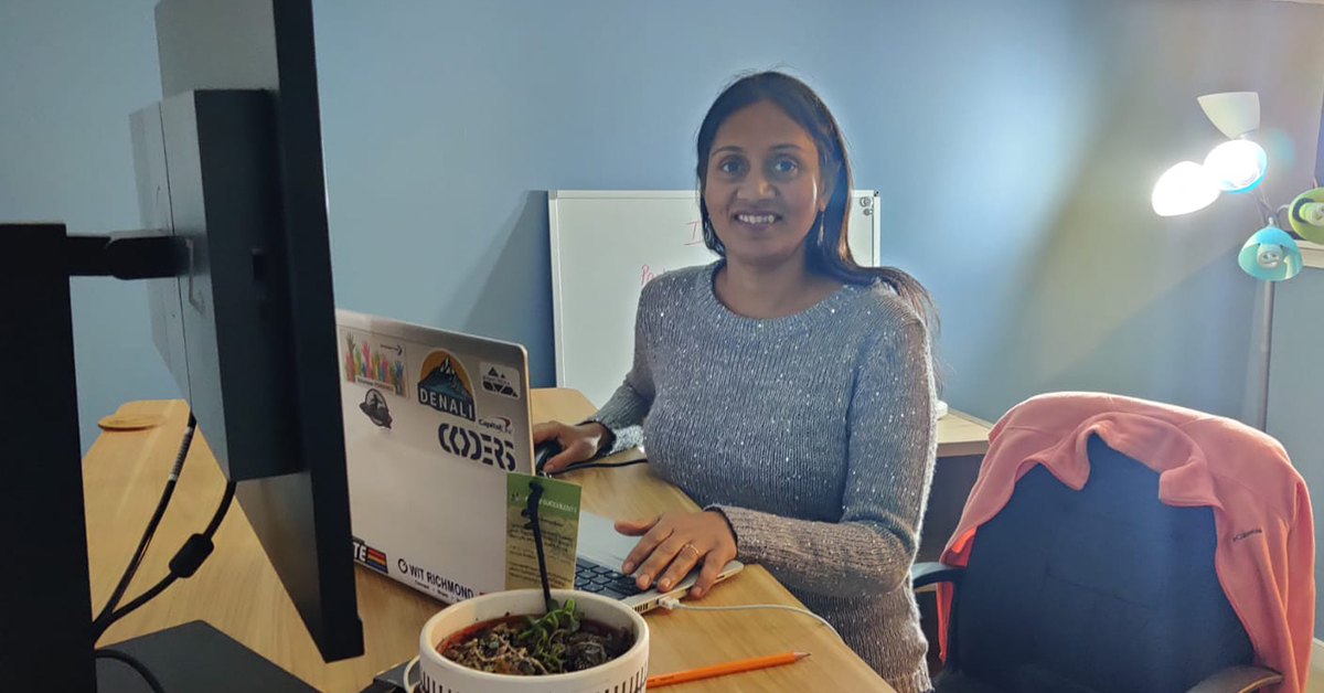 Capital One associate sits at her workspace