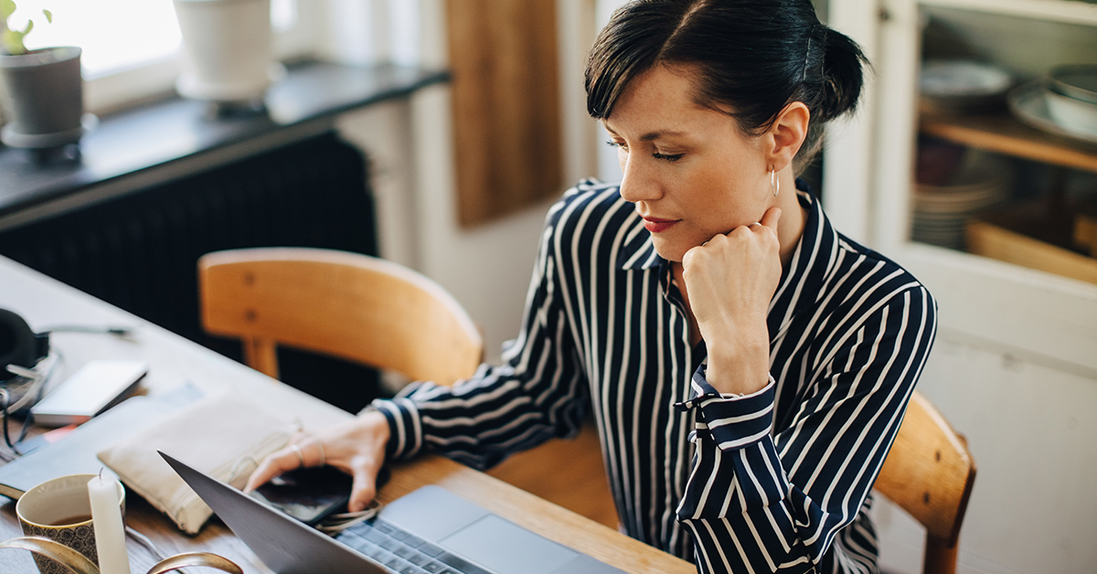 Capital One associate sits at her desk and works from home