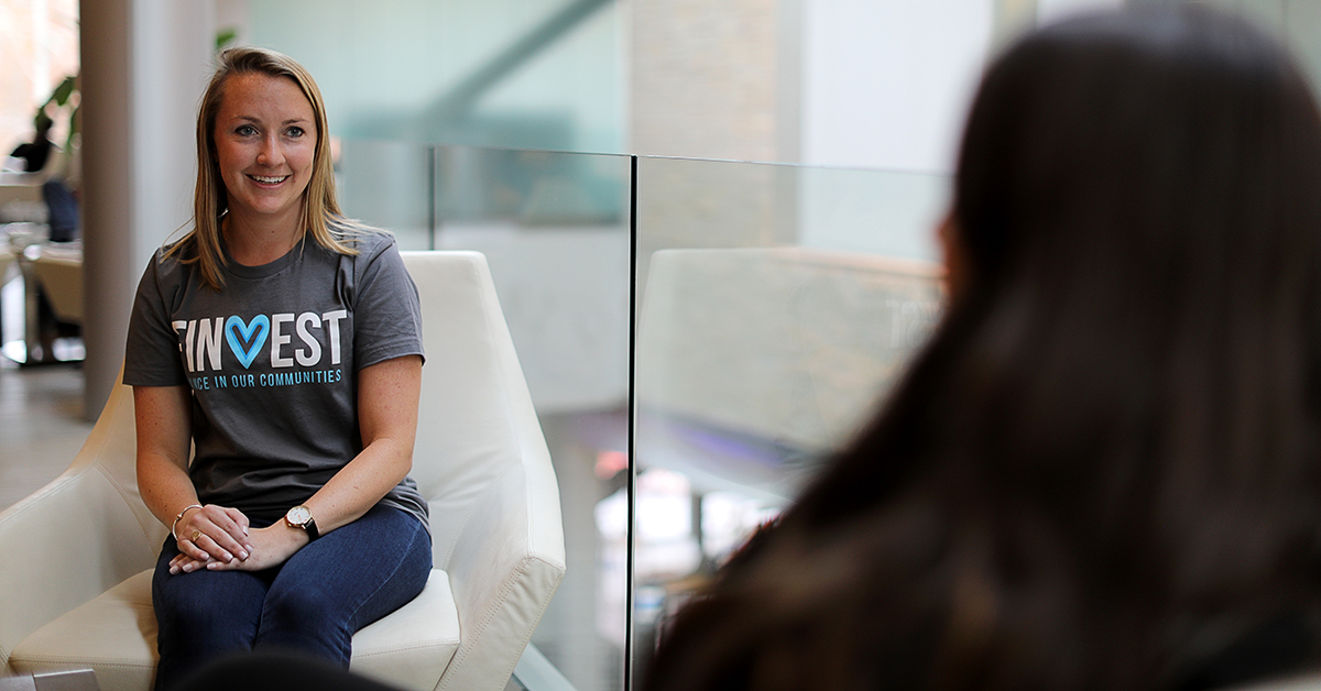 Shannon talking with colleague in Finvest shirt