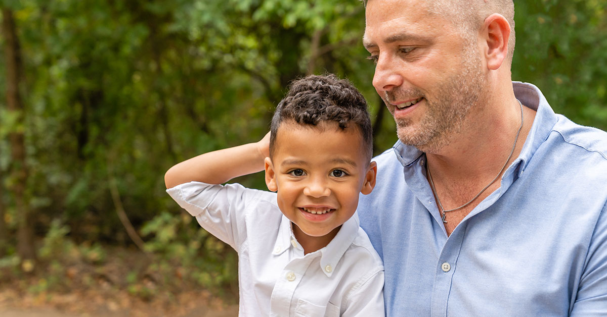 adopted son smiling with his dad