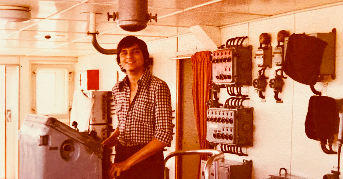 Sanjiv, Capital One Financial Services president, stands on a boat in his early twenties while working for multinational shipping companies