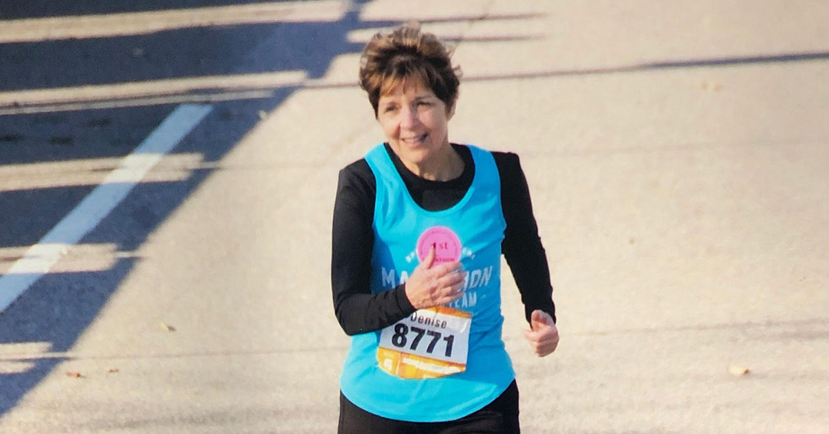 denise running a marathon at the finish line