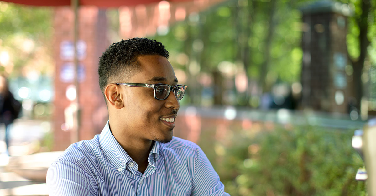 man sitting outside at a table