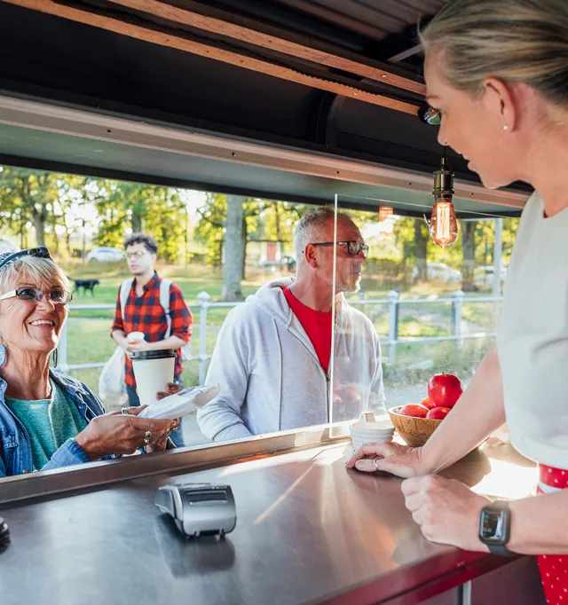 A woman taking food at the food truck