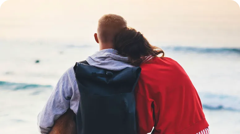 Two person sitting on a beach