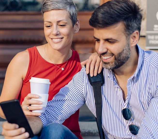 two people looking at a cell phone