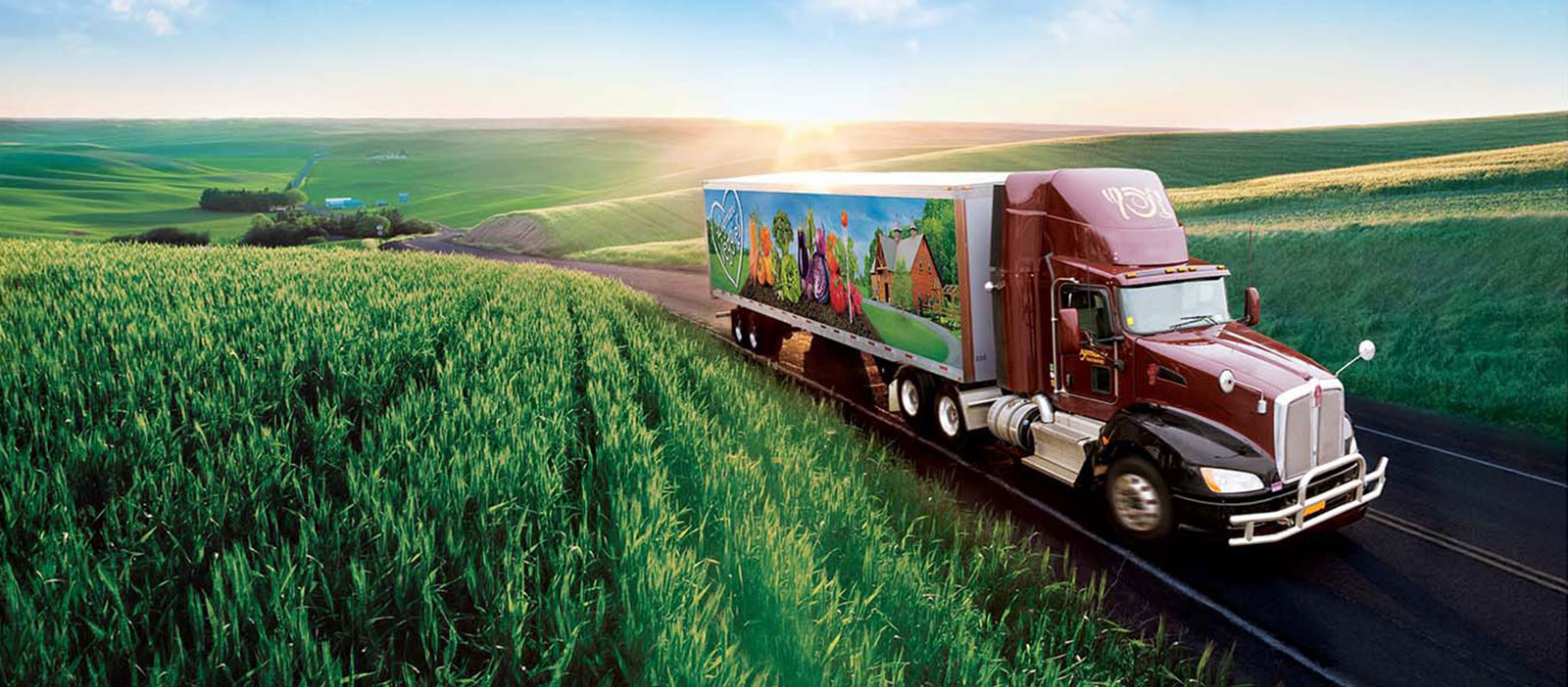 Wegmans truck driving through grassy field