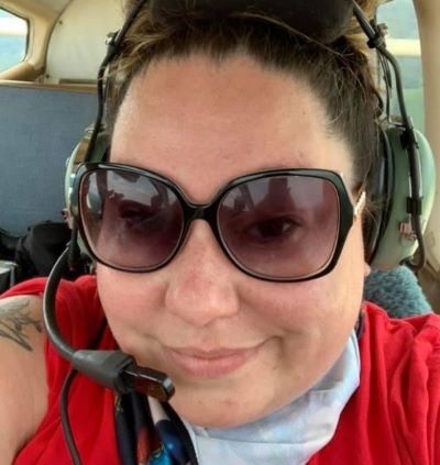 Selfie of Jennifer in the cockpit of an aircraft wearing a headset
