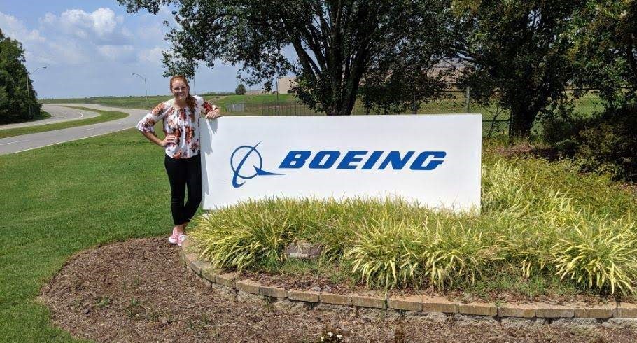 Abbey Carlson standing in front of Boeing signage. 