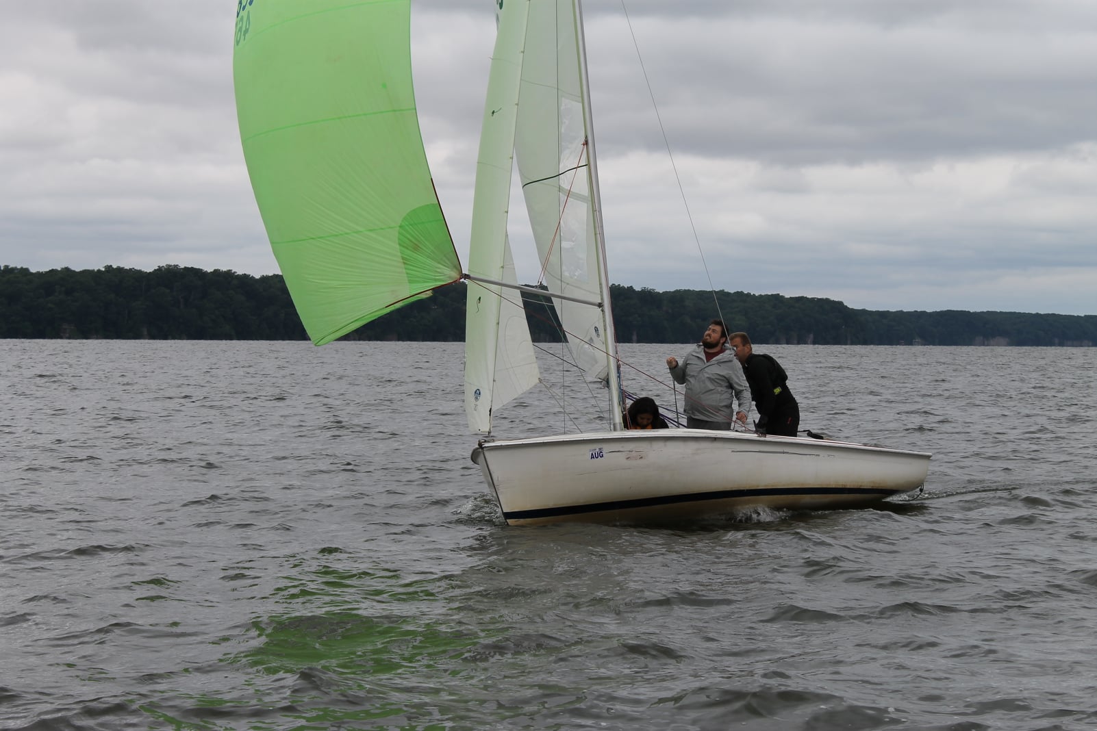 Kyle and his partner sailing a boat. 