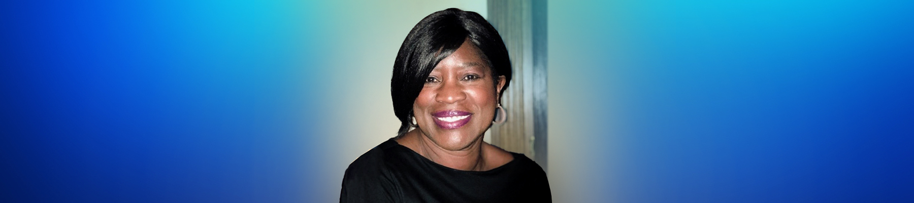 Portrait image of Sandra, looking to camera and smiling. 