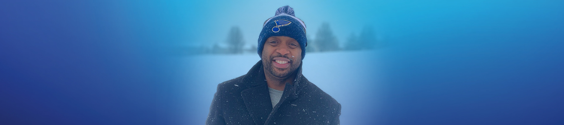 Portrait photo of Terrence Chance standing in snow, smiling to camera