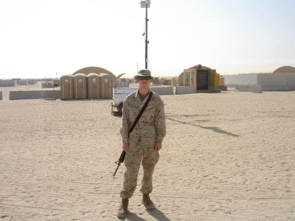 Photo of Derek standing while on deployment for the U.S. Marine Corps in Kuwait