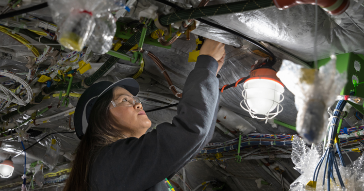 Woman working on fuselage