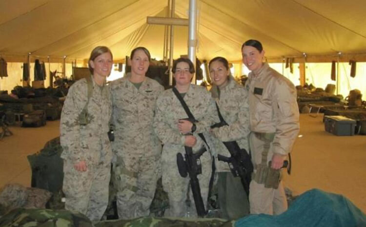 Melissa with fellow military personel in a large tent