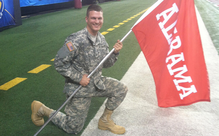 Scott Harkey holding a flag during the pre-game flag ceremony at the SEC Championship Game
