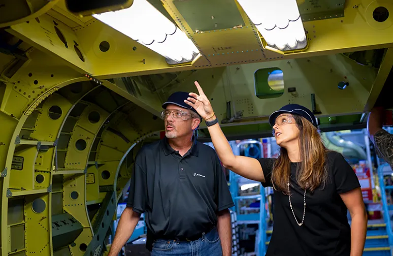 male and female engineer inspecting an aircraft's inner hull