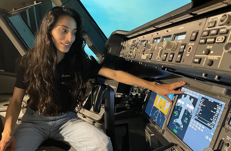 female engineer testing the control panel in an airplane cockpit