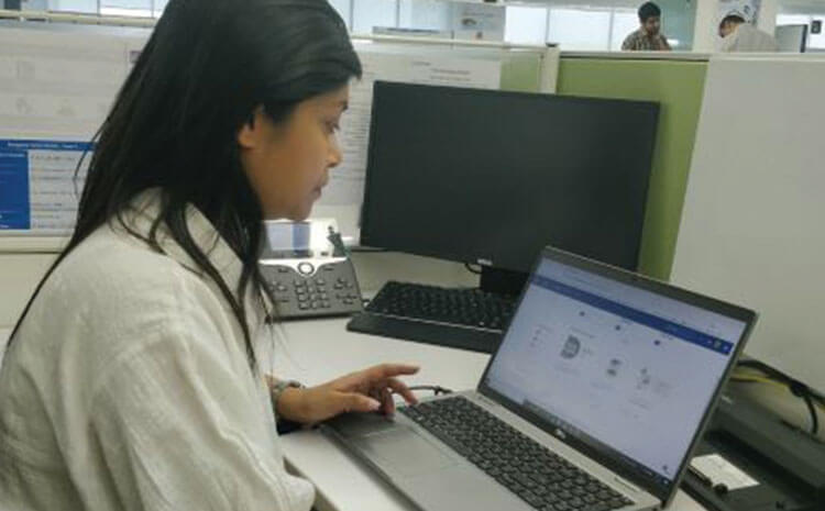 Antara working at her desk on a laptop