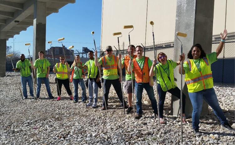 Group of employees in construction vests.