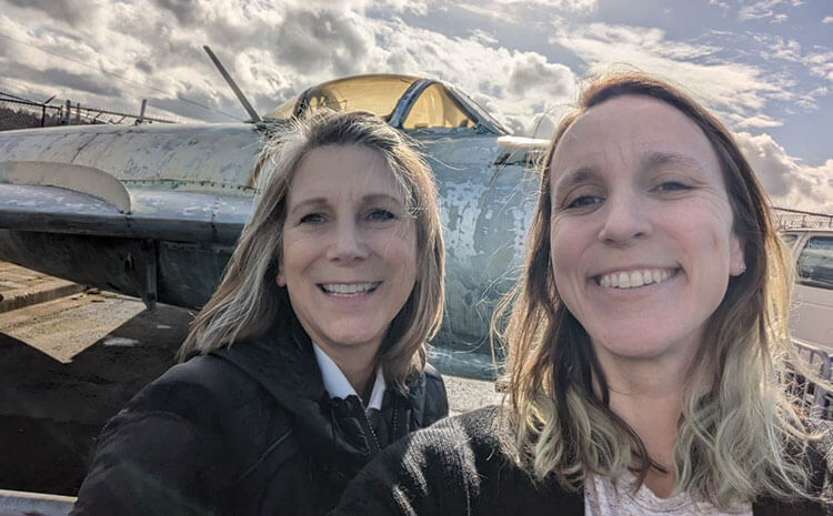 Kay and Denise in front of plane