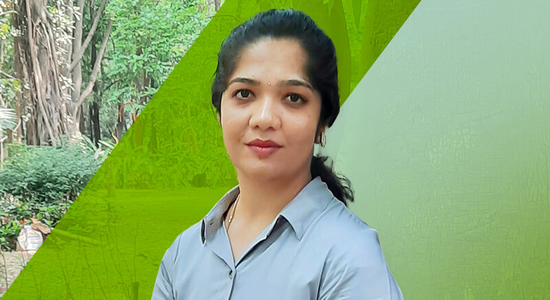 Shruthi in front of green background
