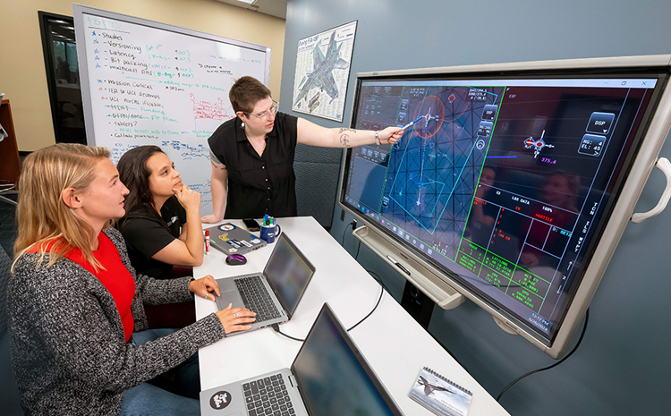 Employees looking at a computer screen
