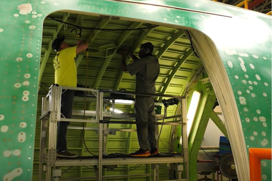 Two mechanics working in plane body