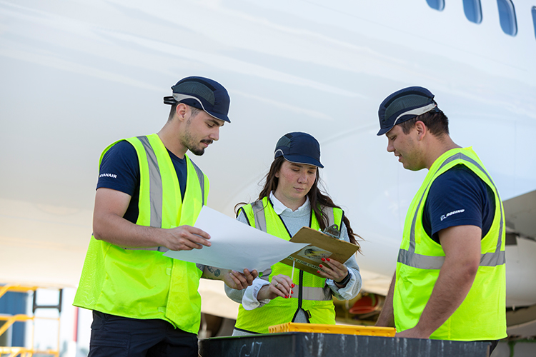 Three mechanic employees in hi vis vests