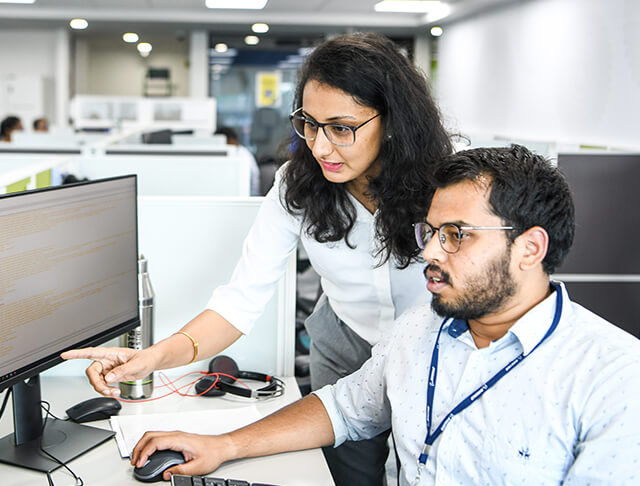 two employees at a computer