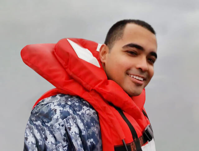 Alex Campos wearing a military uniform and a life preserver