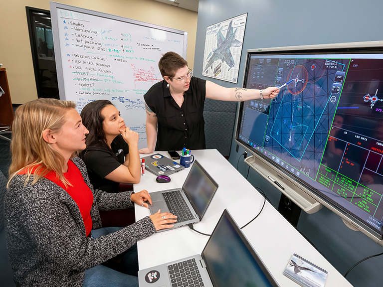 Employees looking at a computer screen