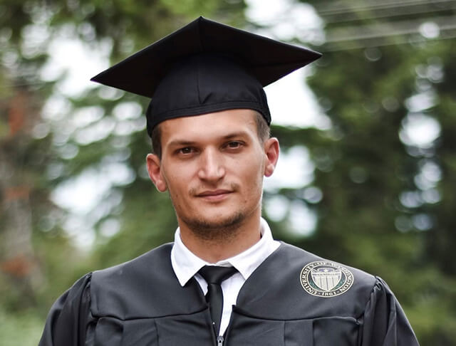 Headshot of Vadym wearing a graduation cap and gown