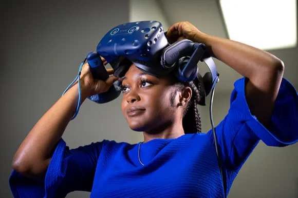 black female employee wearing a VR headset