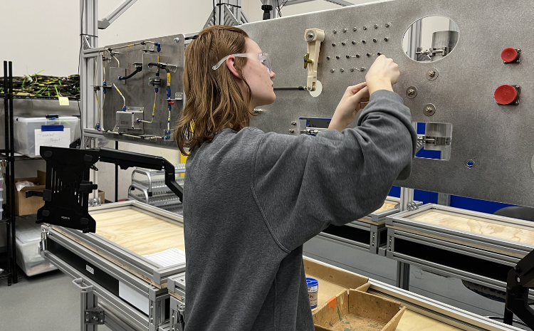 Student Lydia H. performs the same tasks as those required in the factory, right down to the identical bolts. (Boeing photo)