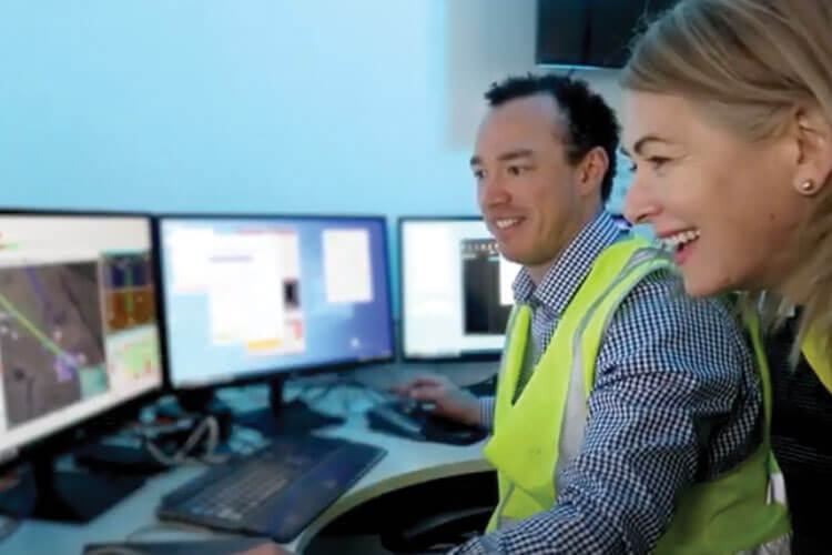 two employees in front of computers