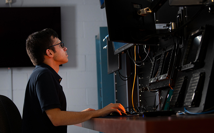 male and female software engineer looking at a computer screen together