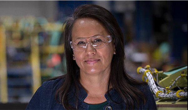 Lady smiling and wearing safety glasses