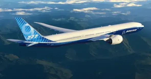 Boeing 777X plane flying over mountains