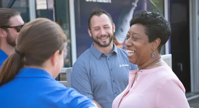 3 Boeing employees chatting with a prospective employee at a hiring event
