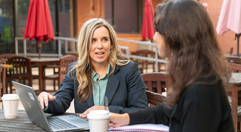 3 Boeing employees chatting with a prospective employee at a hiring event